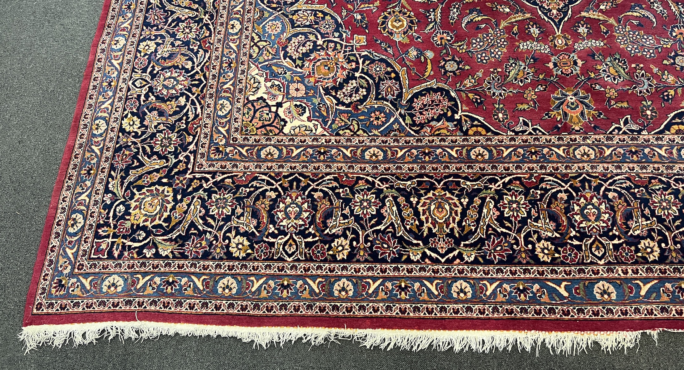 A Kashan burgundy ground carpet